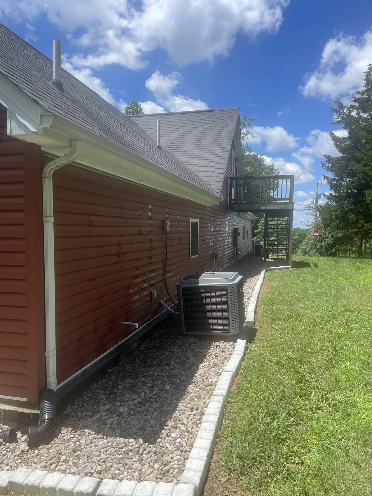 Roofline, gutters, siding, and exterior wall ready for soft washing