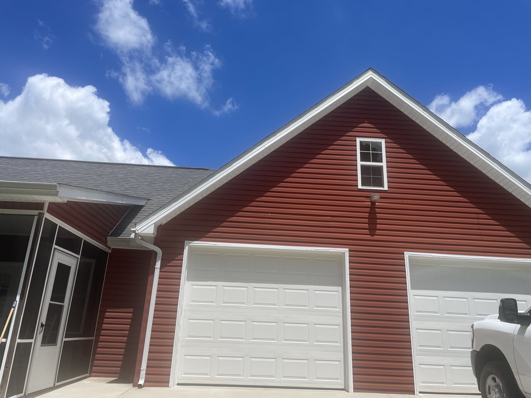 Red home siding and garage exterior after soft washing